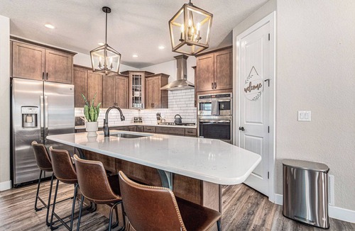 Gleneagle House | 5 Bedroom house with amenities galore! Oversized hot tub, outdoor fire pit, smoker and propane grill, sauna, play set, espresso machine, air hockey table, indoor fireplace in both living rooms, and legacy bar.