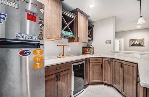 Gleneagle House | 5 Bedroom house with amenities galore! Oversized hot tub, outdoor fire pit, smoker and propane grill, sauna, play set, espresso machine, air hockey table, indoor fireplace in both living rooms, and legacy bar.