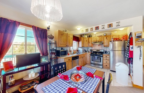Florissant House | A-frame home lined by trees with wood stove, balcony, children's items, & W/D