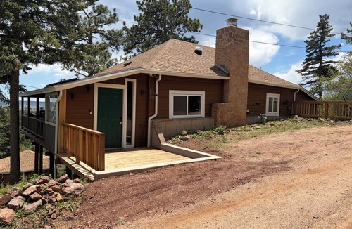 Palmer Lake House | Built in 1908 this historic cabin is full of original charm with a penthouse view. Step inside and you are immediately greeted by a full unobstructed view of Elephant Rock. Sleeping up to 9 people.