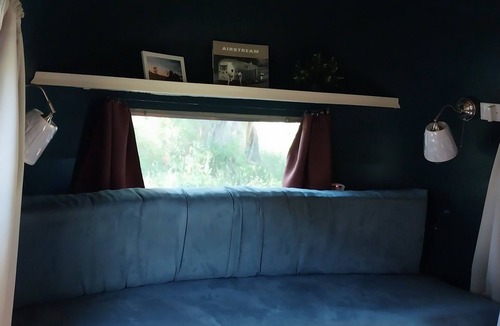 Larkspur House | Cozy camper by the creek, surrounded by serenity and nature.