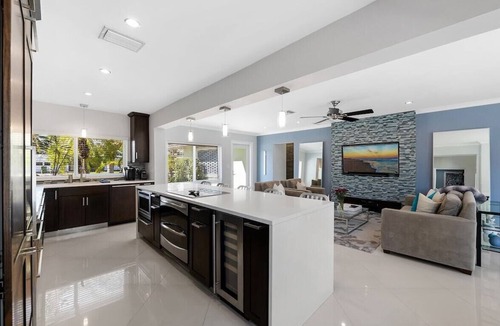 Poinsettia Heights House | Just 10min to downtown Ft. Lauderdale & beach, this modern home offers everything a group could want for an upscale relaxing getaway. Unwind in the very private and peaceful backyard oasis, featuring a heated pool ($), 6-person hot tub & fire pit.