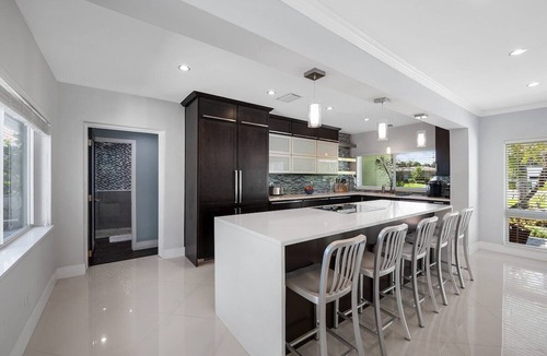 Poinsettia Heights House | Just 10min to downtown Ft. Lauderdale & beach, this modern home offers everything a group could want for an upscale relaxing getaway. Unwind in the very private and peaceful backyard oasis, featuring a heated pool ($), 6-person hot tub & fire pit.