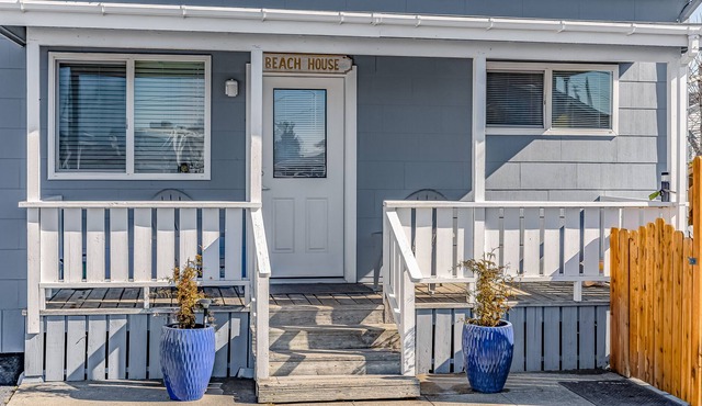 Enjoy views of the beach, the bay, & the canal from this dog-friendly home!