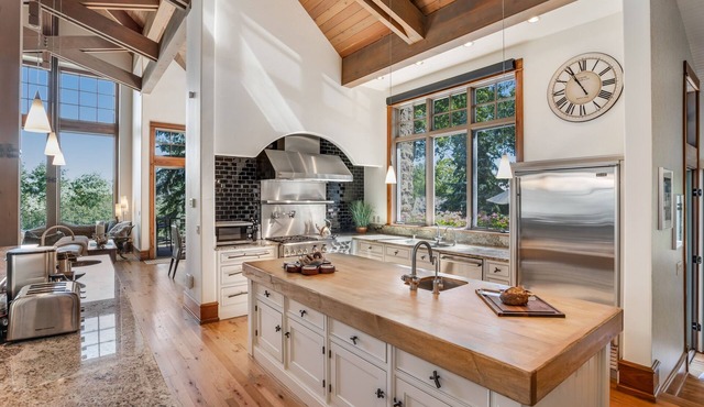 Luxury estate with grand outdoor space, hot tub, game room, & two kitchens