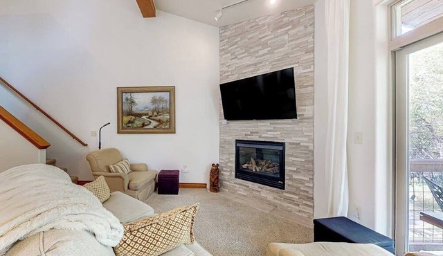 Two-story, riverfront condo with balcony & fireplace - close to everything
